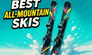 Dwie pary nart all mountain z kolorowymi akcentami, gotowe na zjazd po ośnieżonych stokach.